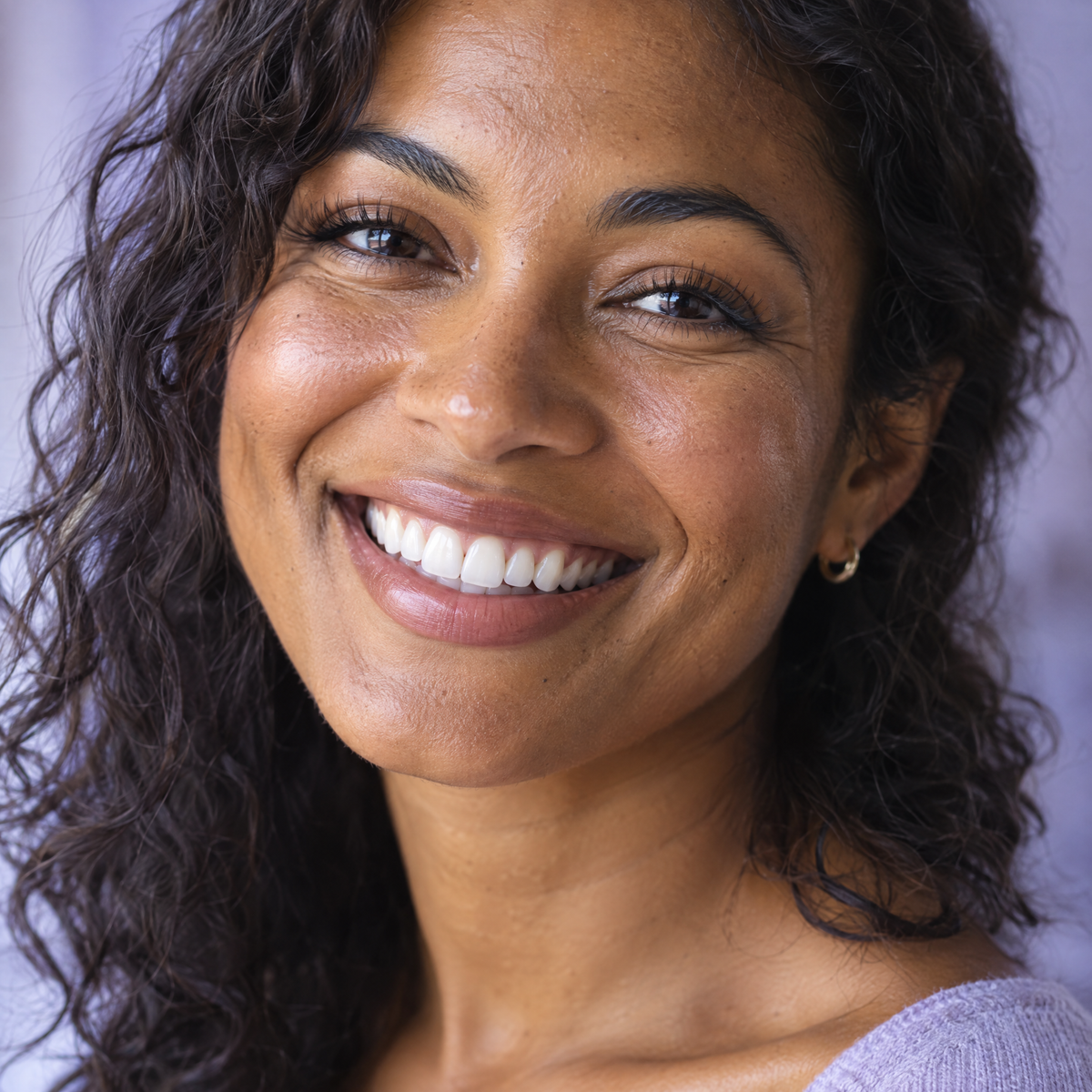 Close-up of a woman with a big natural bright smile