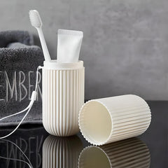 Open travel toothbrush case holding a toothbrush and toothpaste