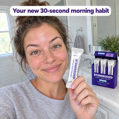 Woman holding a Byenergized purple mouthwash sachet in her bathroom